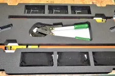 Thumbnail for Rescue tool kit in black foam casing with bolt cutters and two orange crowbars on wooden surface.