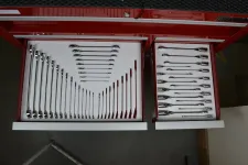 Thumbnail for Organized red tool chest drawers filled with a full set of polished combination wrenches of various sizes.