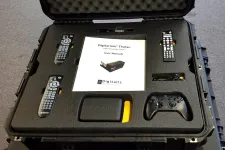 Thumbnail for Portable Digitalis Digitarum Theta+ system with remotes, user manual, controller, and accessories organized in protective case.
