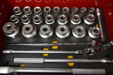 Thumbnail for Set of chrome socket wrench heads and extension bars neatly organized in a red toolbox case.