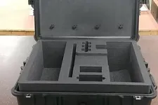 Thumbnail for Open black hard case with custom foam compartments on a workbench in a workshop environment