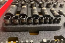 Thumbnail for Close-up of a socket wrench set with various sizes neatly arranged in a foam tray, showing detailed TK branding.