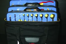 Thumbnail for Open black tool bag displaying organized wrenches, pliers, screwdrivers, and sockets with blue tool holders.