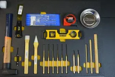 Thumbnail for Set of precision hand tools including chisels, level, tape measure, and metal parts on black foam.