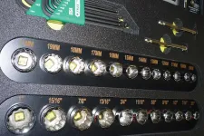 Thumbnail for Set of various sized socket wrench heads and green hex keys in a black toolbox organizer.