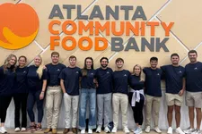 Thumbnail for Group of volunteers standing in front of Atlanta Community Food Bank sign with overlaid text reading Atlanta Community Food Bank