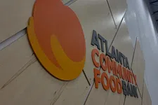 Thumbnail for Wall sign with large orange and yellow fruit logo and text reading Atlanta Community Food Bank