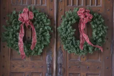 Thumbnail for a group of red and green scarfs on a wooden door