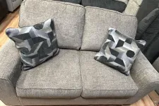 Thumbnail for a pair of grey and white socks on a grey couch