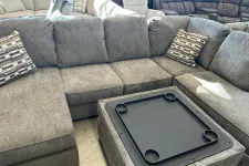 Thumbnail for a black rectangular device on a grey couch