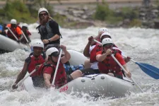 Thumbnail for a group of people riding on a raft in a body of water