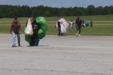 Thumbnail for a group of people walking back from sky diving