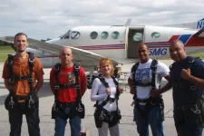 Thumbnail for a group of people standing around a plane