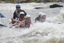 Thumbnail for a group of people getting splashed on a raft