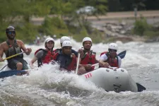 Thumbnail for a group of people riding on a raft in the water