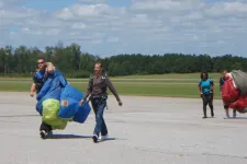 Thumbnail for a group of people walking back from sky diving