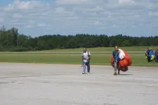 Thumbnail for a group of people walking back from sky diving