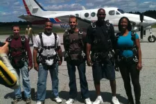 Thumbnail for a group of people standing around a plane