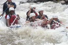 Thumbnail for a group of people riding on a raft in a body of water