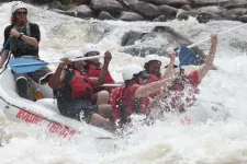Thumbnail for a group of people riding on the rapids in a raft