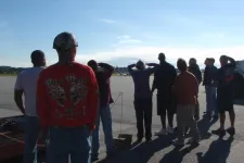 Thumbnail for a group of people standing on a runway