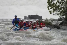 Thumbnail for a group of people riding on a raft in a body of water