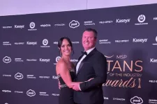 Thumbnail for Couple in formal attire posing on a red carpet at MSP Titans of the Industry Awards event backdrop.