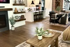Thumbnail for Open living space with wooden floors, modern kitchen, dining area, farmhouse decor, and cozy seating arrangement