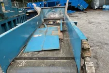 Thumbnail for Close-up of an industrial blue conveyor belt system with metal components in an outdoor setting