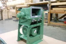 Thumbnail for Green industrial machine with motor, mounted on a base in a workshop with wood and tools in the background