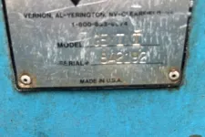 Thumbnail for Close-up of scratched Marathon equipment label showing model and serial number on blue metal surface.