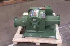 Thumbnail for Green industrial blower mounted on a wooden pallet inside a workshop with concrete floor.