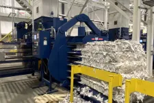 Thumbnail for Industrial baler machine compressing large bundles of shredded paper in a recycling facility