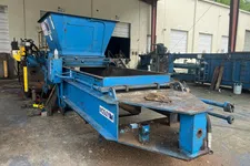 Thumbnail for Blue Mosley industrial metal baler machine in a warehouse with open hopper and conveyor.