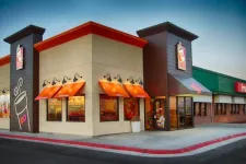 Thumbnail for Dunkin' Donuts storefront with orange awnings and coffee cup logo on a clear day
