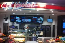 Thumbnail for Interior of Kitchens fast food restaurant showing menu boards, counter, and food displays under red signage