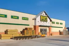 Thumbnail for Exterior view of McCoy's Building Supply store with stacked lumber and wheelbarrows outside under clear sky