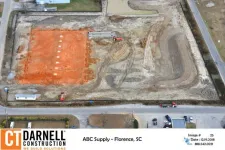 Thumbnail for Aerial view of construction site with excavated red soil area and heavy machinery by CT Darnell Construction