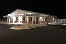 Thumbnail for Night view of Centerville Public Works Department building with illuminated entrance and empty parking lot.