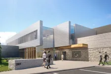 Thumbnail for Modern commercial building with glass and stone facade and people walking outside in daytime under blue sky