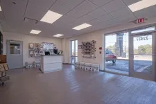 Thumbnail for Bright, clean shipping store interior with counter, packing supplies, and large front windows showing outside view.