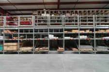 Thumbnail for Organized warehouse shelves stocked with wood planks, pipes, and building materials in a large industrial space