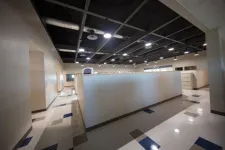 Thumbnail for Modern empty office space with cubicles, polished floors, and overhead industrial lighting.