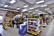Thumbnail for Bright hardware store interior with ladders, shelves stocked with tools, pet food, and various home improvement items.