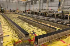 Thumbnail for Indoor construction site with insulated trenches and steel reinforcements for concrete pouring in progress.