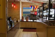 Thumbnail for Interior of a restaurant self-service drink station with Coca-Cola dispenser and colorful hanging lights.