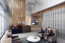 Thumbnail for Modern office lobby with wooden accents, reception desk, seating area, and man reading a tablet.
