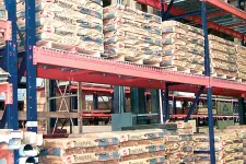 Thumbnail for Warehouse shelves stocked with palletized bags of Timberline cement ready for distribution and storage.