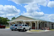 Thumbnail for Centerville Public Works Department building with parked cars under blue sky and white clouds