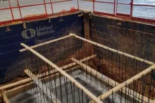 Thumbnail for Concrete foundation rebar framework inside excavation supported by wooden braces at construction site